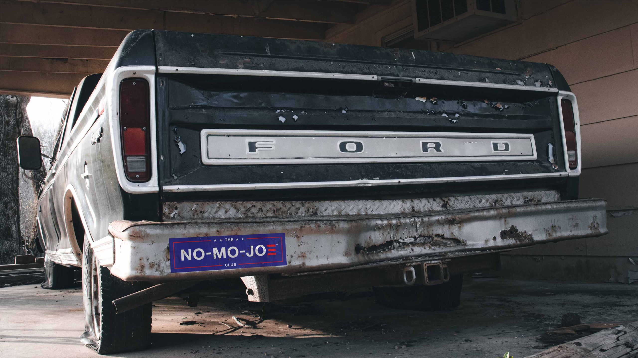 The No-Mo-Joe Club™ bumper sticker on Vintage, Blue Ford pickup truck parked in shop.